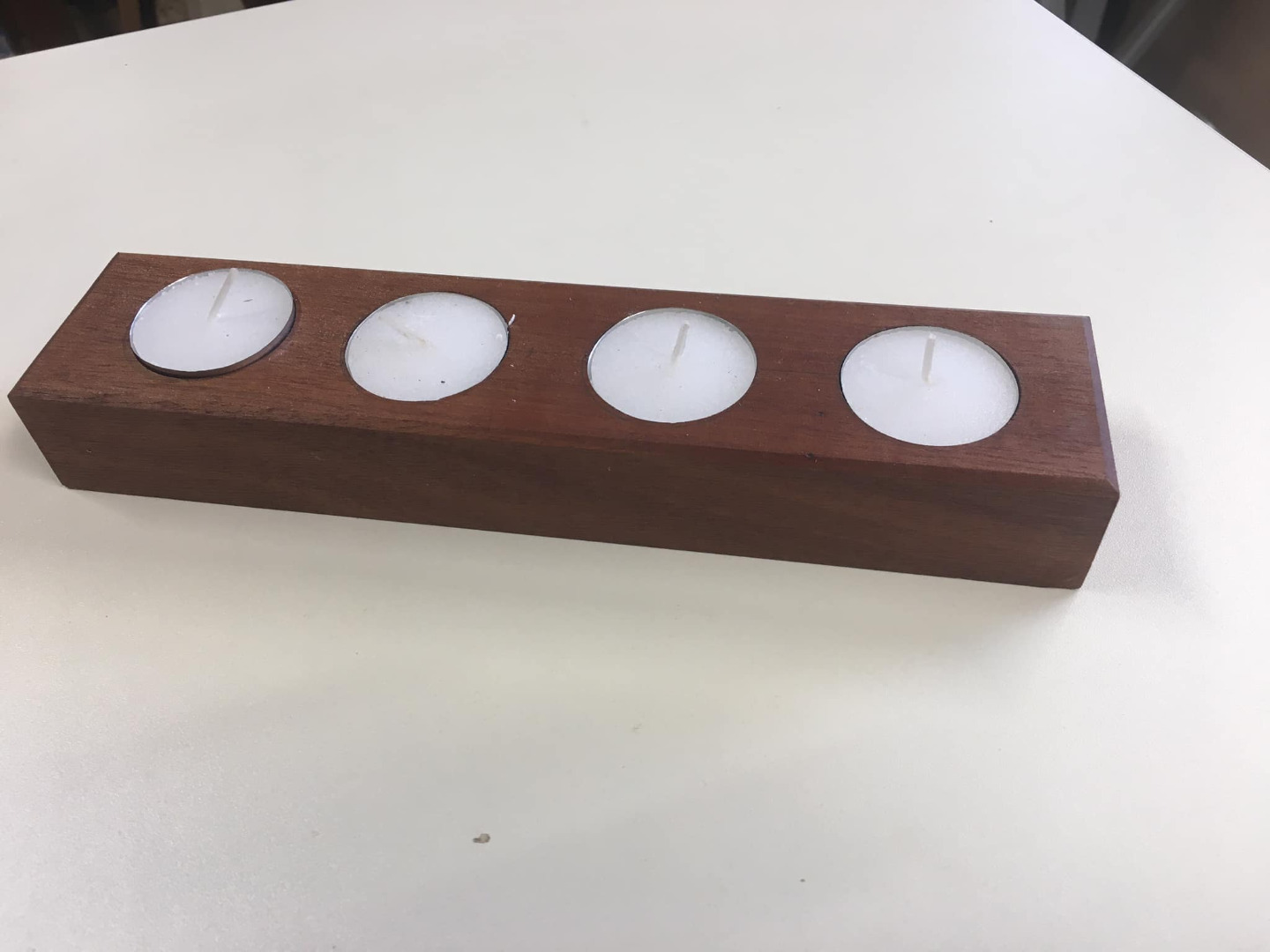 Solid hardwood tea light holder with four recesses