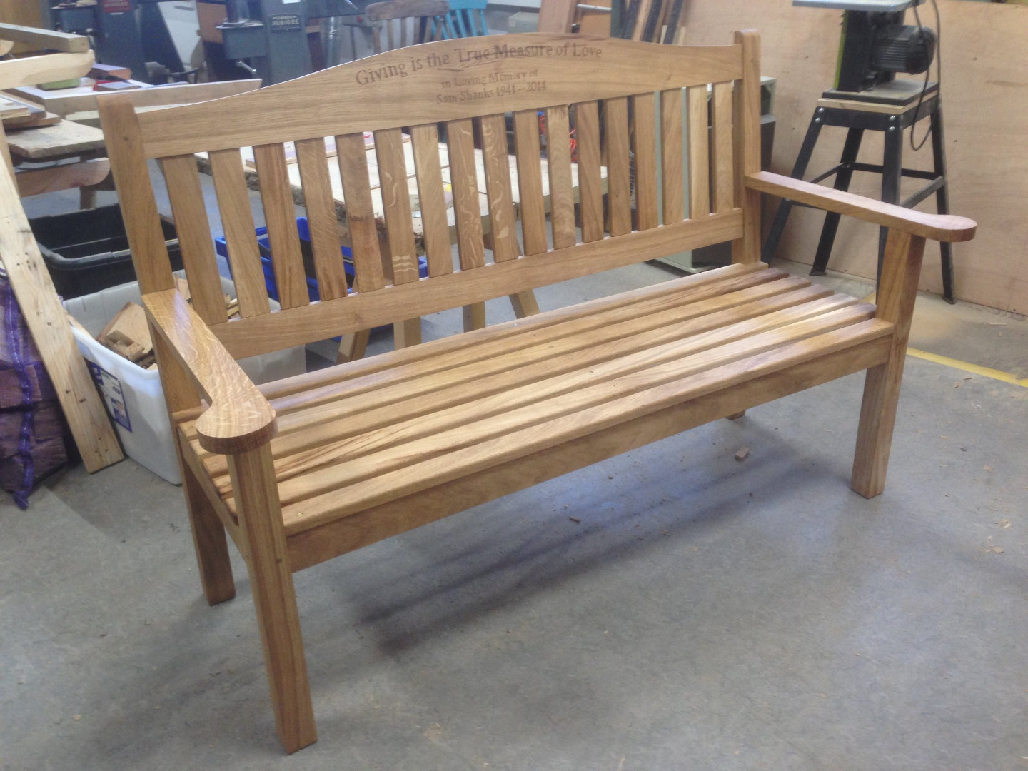 Slatted park bench with armrests in light oak