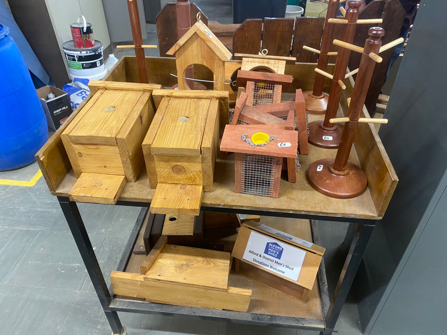Display of handmade items including bird boxes, feeders and wooden stands
